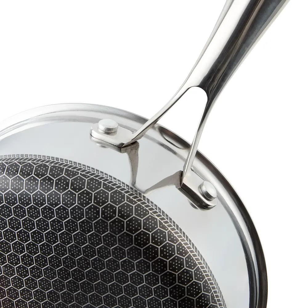 Close-up of a riveted HexChef stainless steel handle and the honeycomb cooking surface